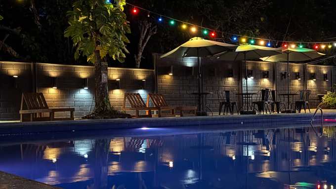 The pool at night under colorful string lights